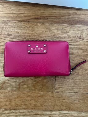 kate spade hot pink zip-around wallet with logo plaque